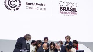 Officials in discussion at the panel of the final COP30 plenary